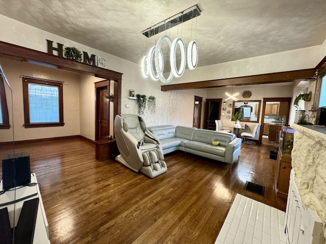 144 N Brighton Ave, Kansas City, MO 64123 - living area with dark wood finished floors and a textured ceiling