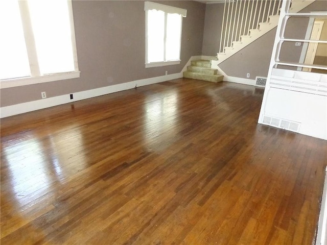 1915 S Broadway St, Pittsburg, KS 66762 - unfurnished living room with stairway and hardwood / wood-style flooring