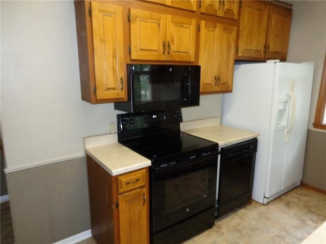1915 S Broadway St, Pittsburg, KS 66762 - kitchen with black appliances, light countertops, and brown cabinetry