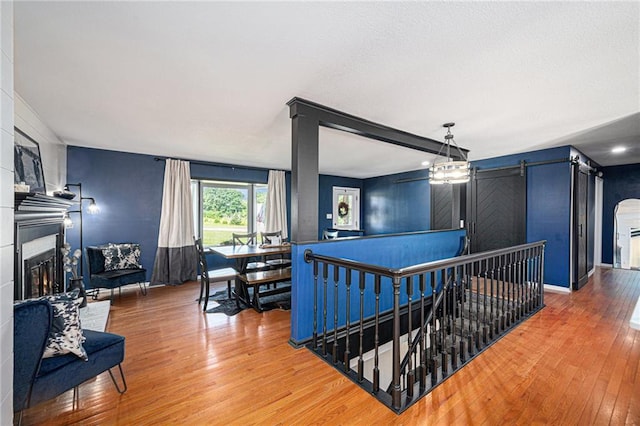37156 State Hwy N, Barnard, MO 64423 - hall featuring an upstairs landing, hardwood / wood-style flooring, and a barn door