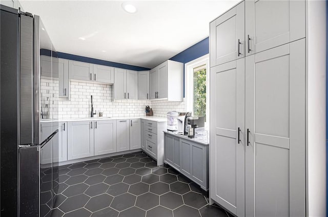 37156 State Hwy N, Barnard, MO 64423 - kitchen featuring freestanding refrigerator, light countertops, backsplash, dark tile patterned floors, and recessed lighting