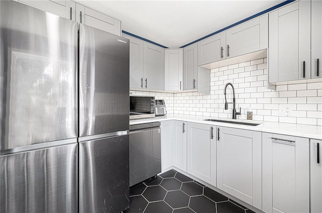 37156 State Hwy N, Barnard, MO 64423 - kitchen with appliances with stainless steel finishes, dark tile patterned floors, light countertops, and tasteful backsplash