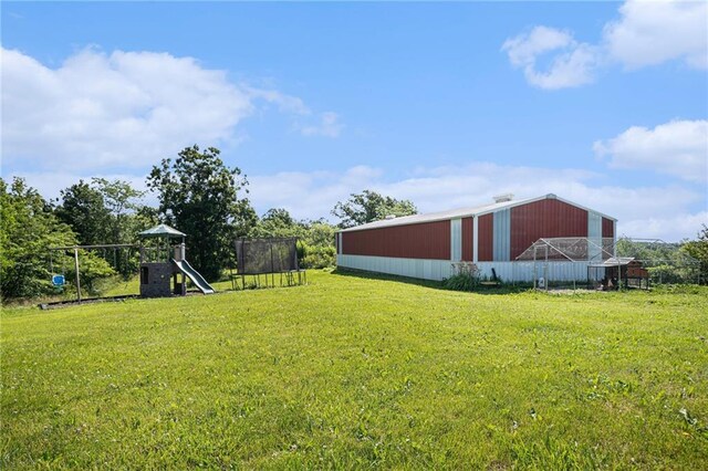 37156 State Hwy N, Barnard, MO 64423 - view of grassy yard featuring a trampoline, an outbuilding, and a playground