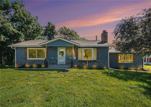 37156 State Hwy N, Barnard, MO 64423 - view of front of property featuring a lawn, stone siding, a chimney, and a porch