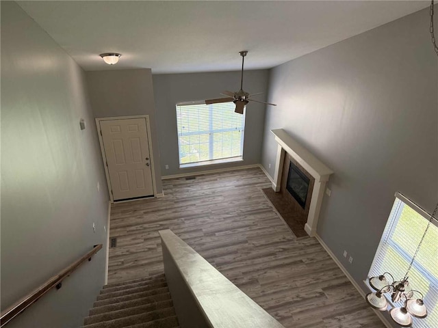 8808 NE 97th St, Kansas City, MO 64157 - stairs with a fireplace with flush hearth, wood finished floors, and ceiling fan
