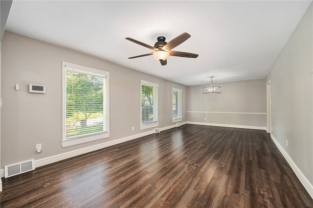 109 NE Locust St, Blue Springs, MO 64014 - unfurnished room featuring dark wood-type flooring, a chandelier, and a ceiling fan