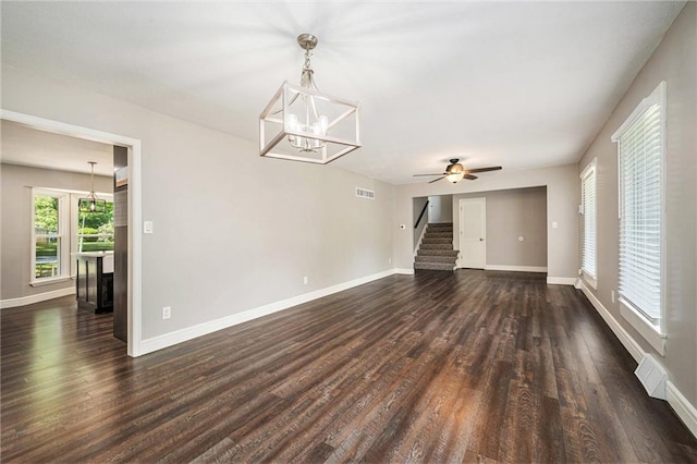 109 NE Locust St, Blue Springs, MO 64014 - unfurnished living room featuring dark wood-style floors, a chandelier, stairway, and ceiling fan