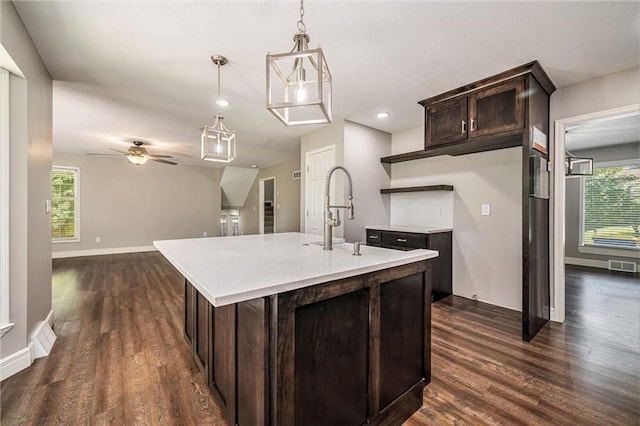 109 NE Locust St, Blue Springs, MO 64014 - kitchen featuring dark wood-style floors, light countertops, dark brown cabinets, healthy amount of natural light, and recessed lighting