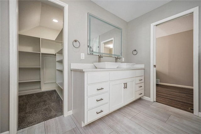 109 NE Locust St, Blue Springs, MO 64014 - bathroom with vanity, wood finished floors, and a walk in closet