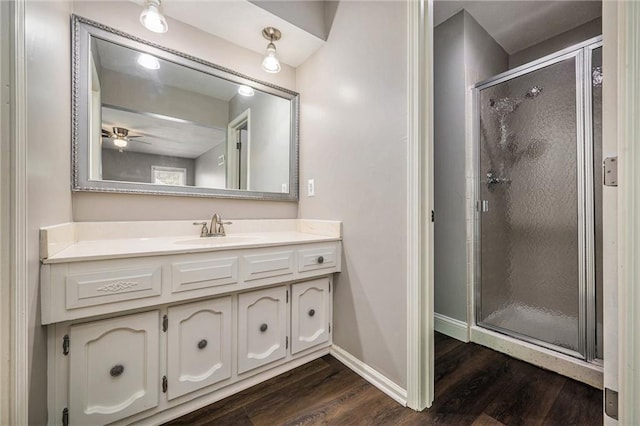 109 NE Locust St, Blue Springs, MO 64014 - bathroom featuring wood finished floors, vanity, a stall shower, and ceiling fan