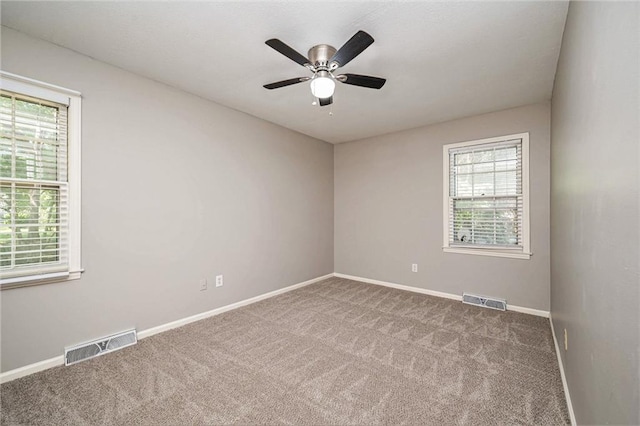 109 NE Locust St, Blue Springs, MO 64014 - unfurnished room with carpet flooring, plenty of natural light, and a ceiling fan