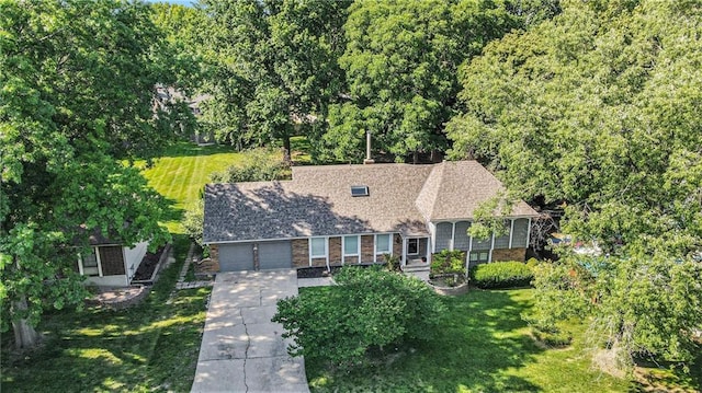 109 NE Locust St, Blue Springs, MO 64014 - view of front of home with concrete driveway, a front lawn, and an attached garage