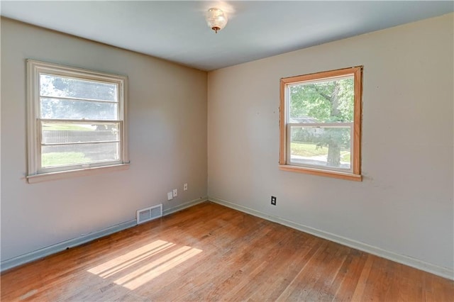 1700 S Pearl St, Independence, MO 64055 - empty room featuring light wood-style flooring and baseboards