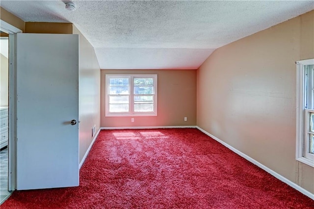 1700 S Pearl St, Independence, MO 64055 - unfurnished room with vaulted ceiling, a smoke detector, carpet floors, and a textured ceiling