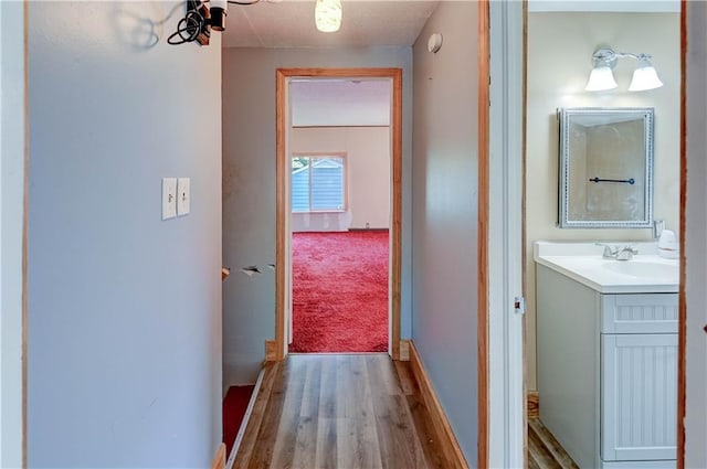 1700 S Pearl St, Independence, MO 64055 - hall featuring wood finished floors and a sink