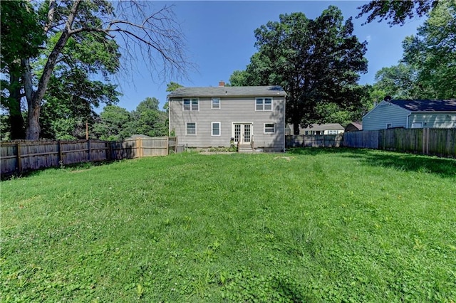 1700 S Pearl St, Independence, MO 64055 - back of house with entry steps, a fenced backyard, french doors, and a chimney