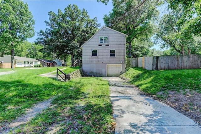 1700 S Pearl St, Independence, MO 64055 - view of yard with concrete driveway and a garage