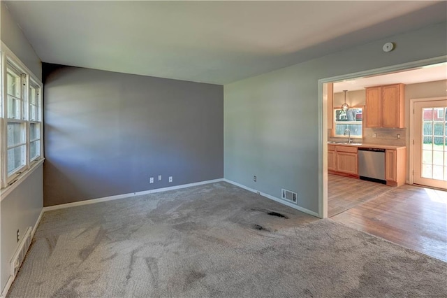 1700 S Pearl St, Independence, MO 64055 - unfurnished room featuring a sink and light colored carpet