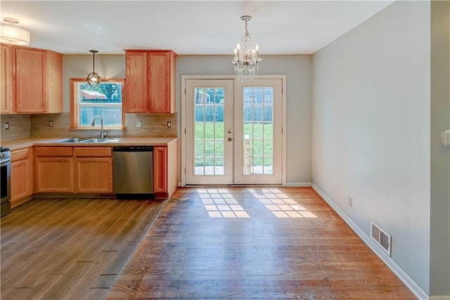 1700 S Pearl St, Independence, MO 64055 - kitchen with dishwasher, plenty of natural light, and wood finished floors