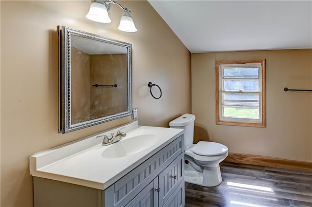 1700 S Pearl St, Independence, MO 64055 - bathroom featuring wood finished floors, vanity, and vaulted ceiling