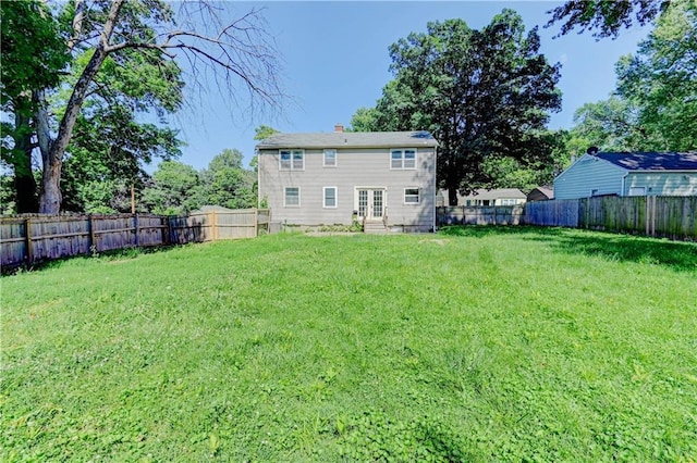 1700 S Pearl St, Independence, MO 64055 - back of house featuring entry steps, a fenced backyard, and a chimney