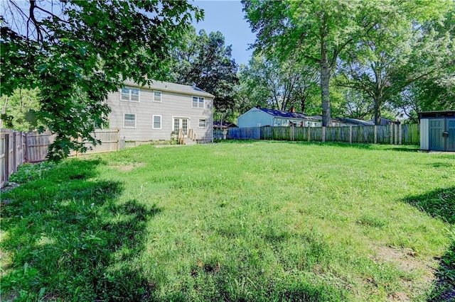 1700 S Pearl St, Independence, MO 64055 - fenced backyard featuring a storage unit and entry steps