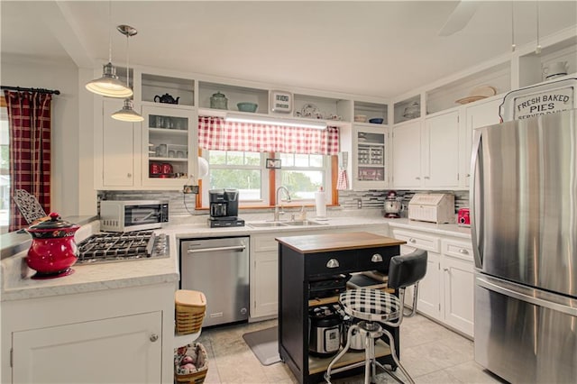 328 E 4th St, Lawson, MO 64062 - kitchen with appliances with stainless steel finishes, tasteful backsplash, light tile patterned flooring, and white cabinets