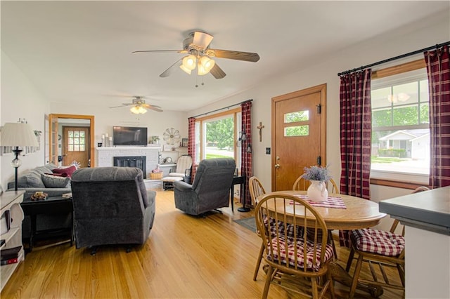 328 E 4th St, Lawson, MO 64062 - living area with light wood finished floors, ceiling fan, and a fireplace