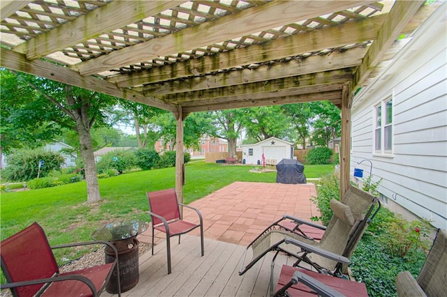 328 E 4th St, Lawson, MO 64062 - deck with a pergola, a lawn, an outbuilding, and a patio area
