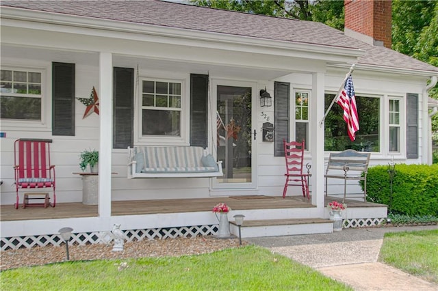 328 E 4th St, Lawson, MO 64062 - entrance to property featuring a porch, a shingled roof, and a chimney