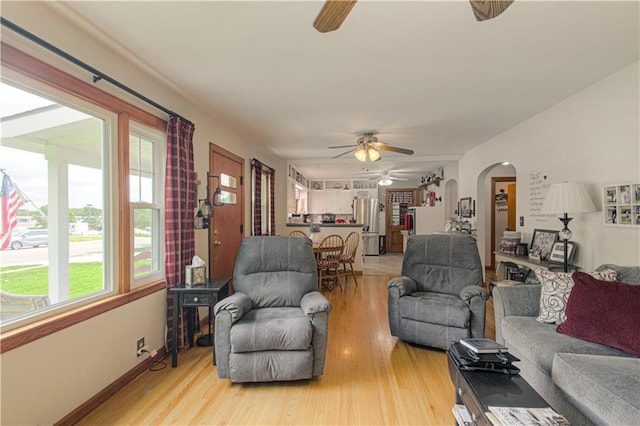 328 E 4th St, Lawson, MO 64062 - living area with ceiling fan, light wood-style floors, and arched walkways
