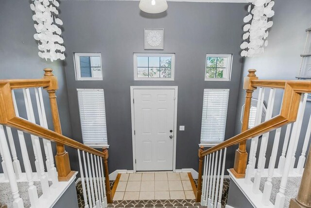 1311 Honeysuckle Ct, Liberty, MO 64068 - foyer entrance featuring tile patterned floors, stairway, and a towering ceiling