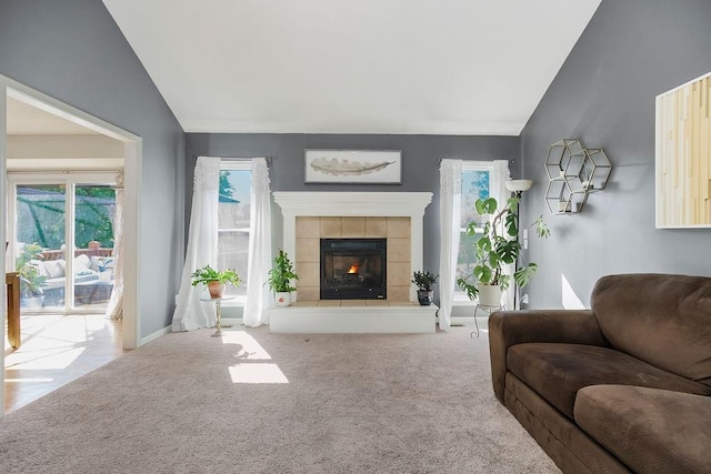 1311 Honeysuckle Ct, Liberty, MO 64068 - carpeted living area with vaulted ceiling and a tile fireplace