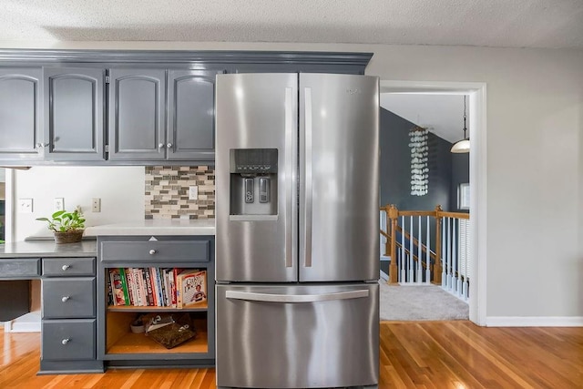 1311 Honeysuckle Ct, Liberty, MO 64068 - kitchen featuring stainless steel refrigerator with ice dispenser, gray cabinetry, light wood-style flooring, a textured ceiling, and tasteful backsplash
