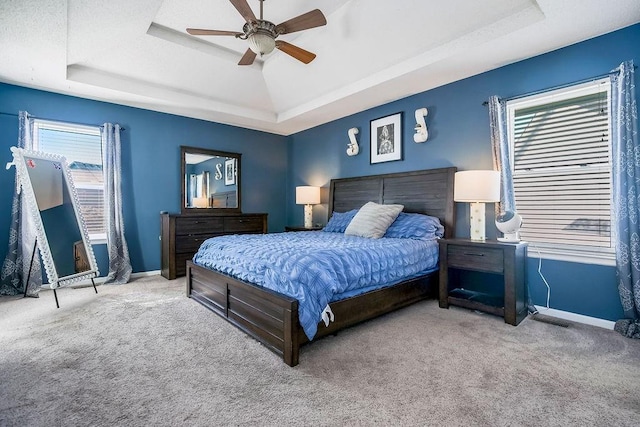 1311 Honeysuckle Ct, Liberty, MO 64068 - bedroom with a tray ceiling, carpet flooring, and a ceiling fan