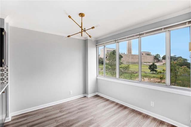 2525 Main St Unit 305, Kansas City, MO 64108 - empty room with a chandelier, wood finished floors, and ornamental molding