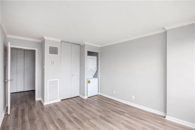 2525 Main St Unit 305, Kansas City, MO 64108 - unfurnished bedroom with light wood-style flooring, ornamental molding, and a closet