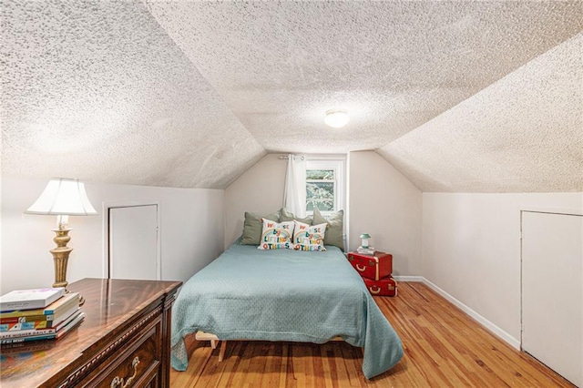5147 Maple Ave, Mission, KS 66202 - bedroom with a textured ceiling, light wood-type flooring, and lofted ceiling