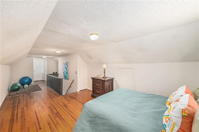5147 Maple Ave, Mission, KS 66202 - bedroom with a textured ceiling, wood-type flooring, and vaulted ceiling