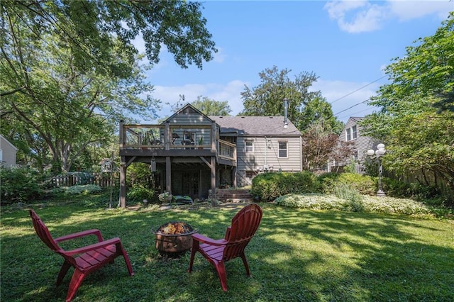 5147 Maple Ave, Mission, KS 66202 - back of property featuring an outdoor fire pit, a deck, and a lawn