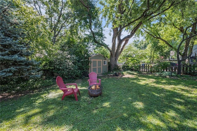 5147 Maple Ave, Mission, KS 66202 - view of yard with an outdoor fire pit and a storage shed