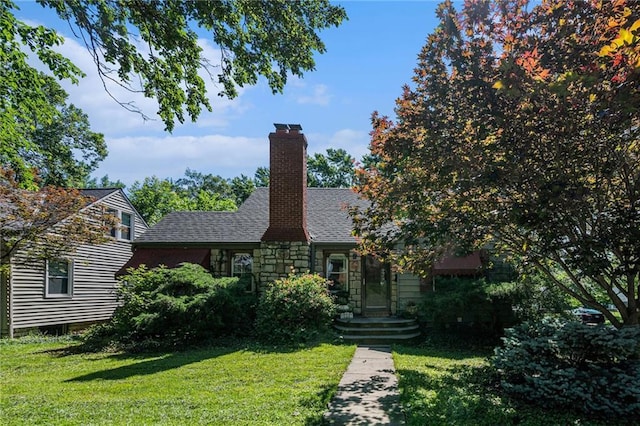 5147 Maple Ave, Mission, KS 66202 - view of front of home featuring a front yard, a chimney, stone siding, and a shingled roof