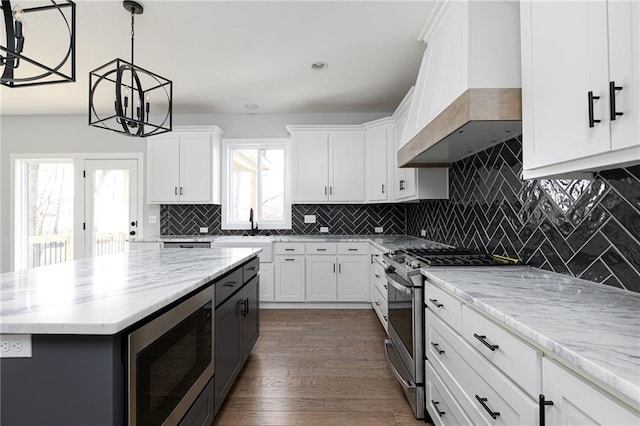 9015 N Colorado Ave, Kansas City, MO 64156 - kitchen featuring appliances with stainless steel finishes, premium range hood, white cabinets, and light stone countertops