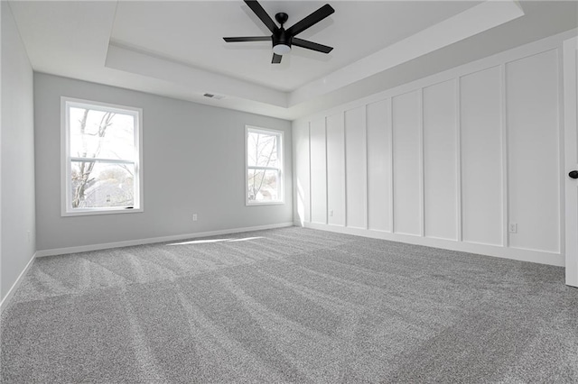 9015 N Colorado Ave, Kansas City, MO 64156 - carpeted empty room featuring a raised ceiling and a ceiling fan