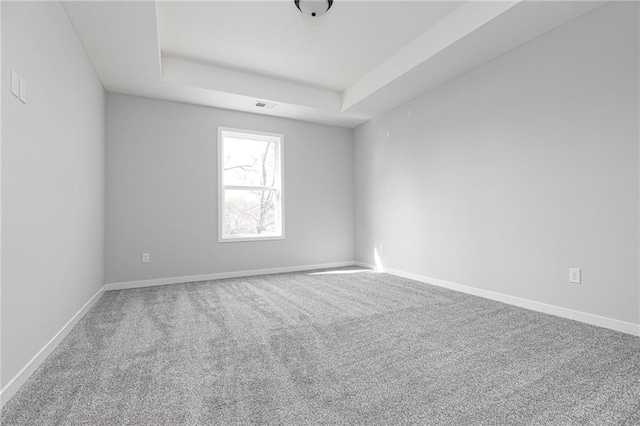9015 N Colorado Ave, Kansas City, MO 64156 - carpeted spare room featuring a tray ceiling and baseboards