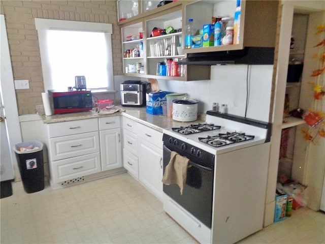 1909 S Broadway St, Pittsburg, KS 66762 - kitchen featuring white gas range, white cabinets, extractor fan, open shelves, and light countertops