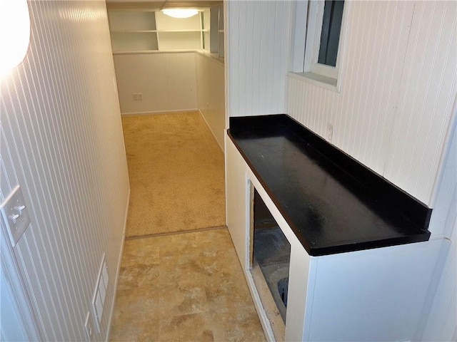 1909 S Broadway St, Pittsburg, KS 66762 - corridor with carpet flooring and wooden walls