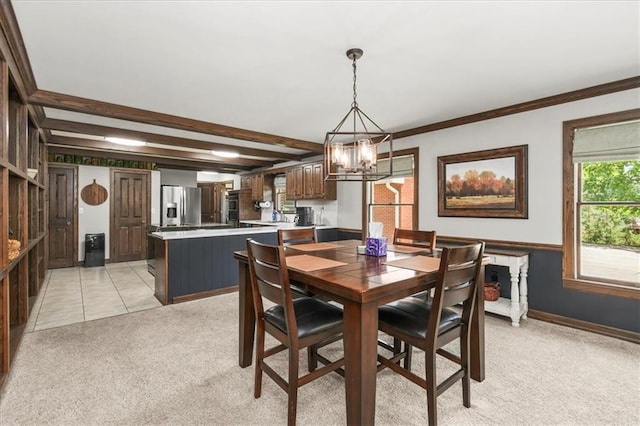 601 Darrow St, Warrensburg, MO 64093 - dining space featuring light carpet, a chandelier, beam ceiling, and ornamental molding