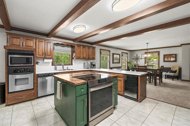 601 Darrow St, Warrensburg, MO 64093 - kitchen with appliances with stainless steel finishes, beverage cooler, green cabinetry, wood counters, and a peninsula