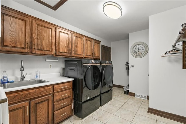 601 Darrow St, Warrensburg, MO 64093 - laundry area with cabinet space, washer and clothes dryer, and light tile patterned floors